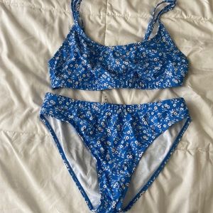 A medium size blue swimsuit with floral design.